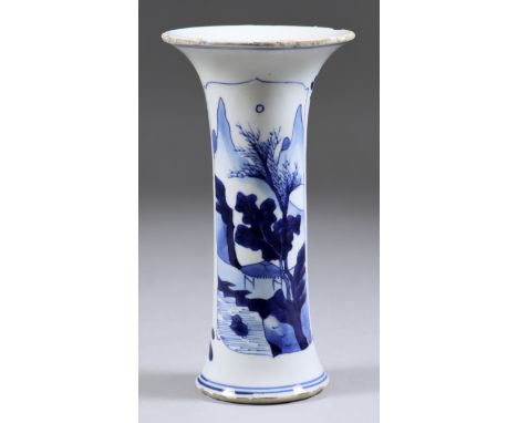 A Chinese Blue and White Porcelain Spill Vase of Waisted Form, Kangxi Period, painted with a mountainous landscape and cherry