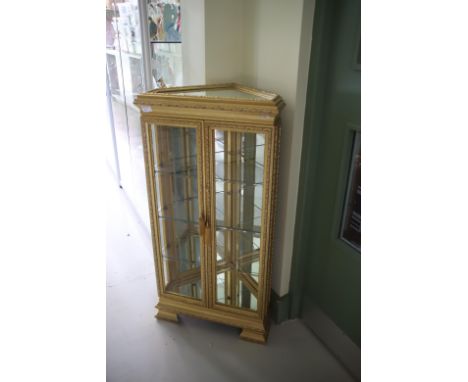 Very Fancy Gilded Glass corner cabinet with three shelves and Mirror top. Raised on Bracket feet it measures H:42 x W:21 x D: