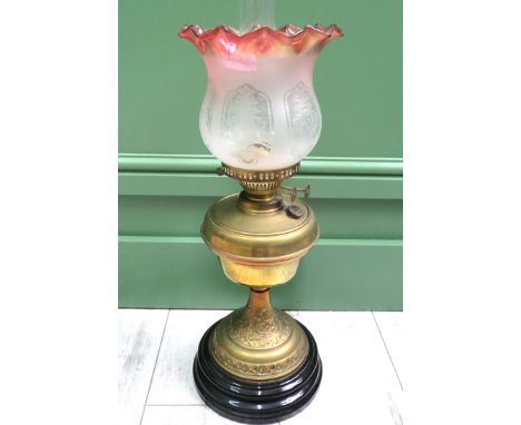 Brass &amp; Glass Oil lamp raised on an Ebonised circular base. Brass Body &amp; Reservoir with etched glass shade, clear chi