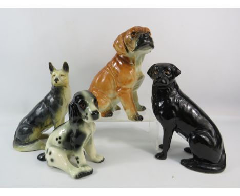 Four vintage dog figurines, the tallest stands 8.5".