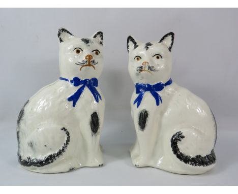 A vintage pair of staffordshire cat figurines, 8" tall.
