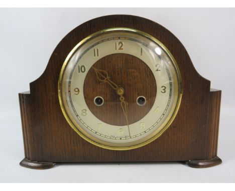 Art deco Smiths wooden mantle clock in working order, with key. 8" tall and 11/.5" wide.