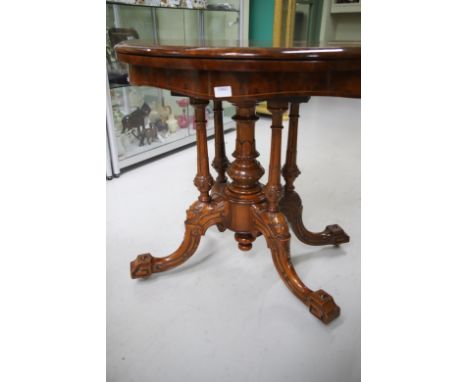 Magnificent Victorian Mahogany fold top games table raised on four carved bracket feet with turned central column and risers.