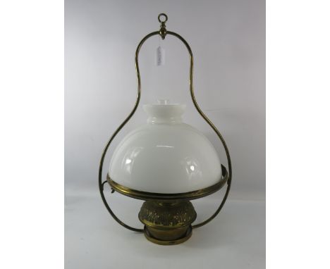 Vintage hanging brass oil lamp with white glass shade, 27" tall and 18" wide.