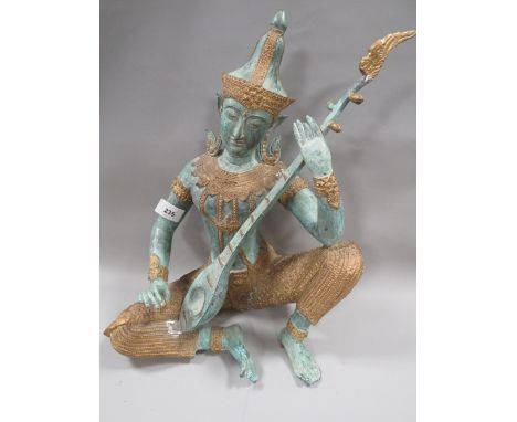 An Indonesian / Bali bronze Hindu figure of a seated female musician, approx height 34.5 cm 