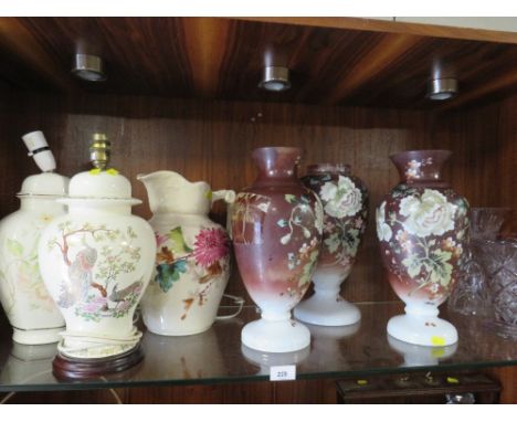 A shelf containing selection of glass vases, ceramic pitcher and two lamps A/F 