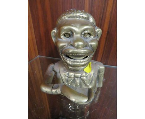 A cast metal brass money bank Notice from the the-saleroom.com: These items are listed on the basis they are illustrative of 