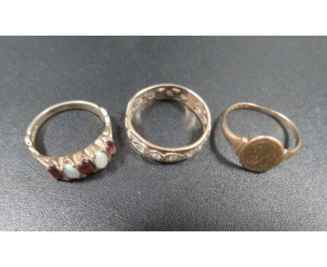 A hallmarked 9ct gold ring approx weight 1.3 g, together with an unmarked eternity ring plus a silver dress ring 
