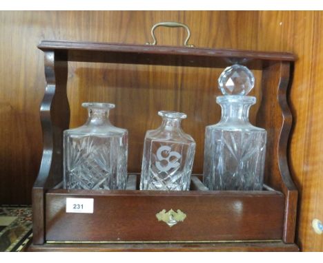 A modern three bottle tantalus and part contents 