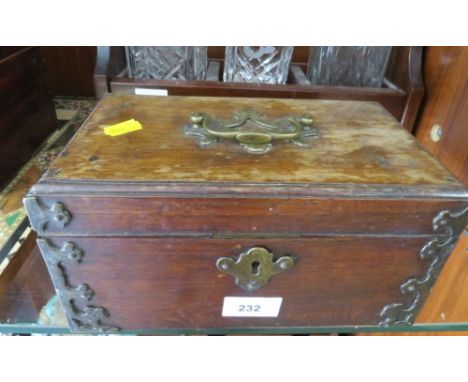 A vintage mahogany tea caddy with brass embellishments 