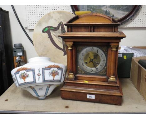 A large vintage mantle clock together with a vintage glass light shade 