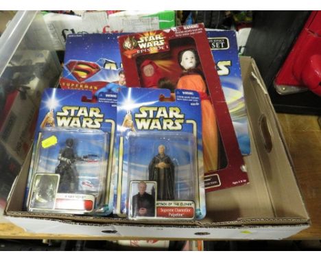 A selection of boxed Star Wars figures and a single packed Superman figure 