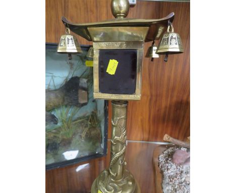 An unusual vintage chinese brass lantern, decorated with dragons and birds with bell drops and fitted with red glass panels H