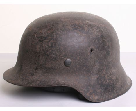 German Army M-42 Steel Combat Helmet complete with the original leather liner and leather chinstrap. Exterior of the helmet h