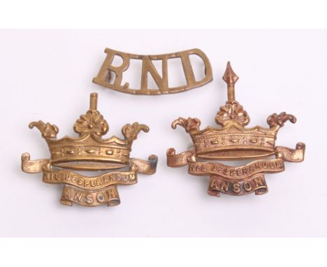 Royal Naval Division Anson Cap Badge in gilt brass with J R Gaunt London makers tablet on the reverse. Original two lug fitti