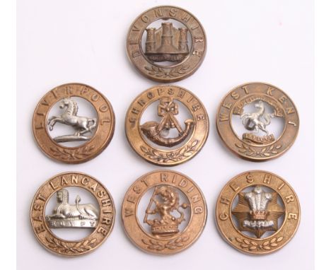 Seven British Helmet Plate Centres including Devonshire regiment, West Kent regiment, Cheshire regiment, Shropshire Light Inf