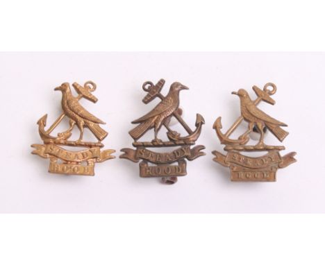 Three Royal Naval Division Hood Collar Badges consisting of a bronzed example with J R Gaunt London makers tablet on reverse,