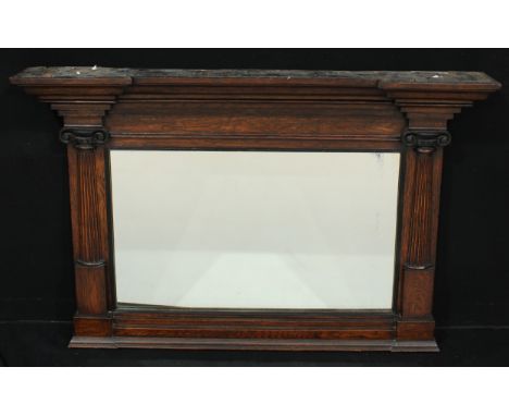An architectural oak chimney glass, rectangular mirror plate flanked by Ionic pilasters, 74.5cm high, 115.5cm wide 