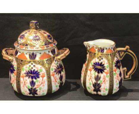 A Derby Crown Porcelain Company Imari palette 1128 pattern Aesthetic Movement cream jug, sucrier and cover, the sucrier 12.5c