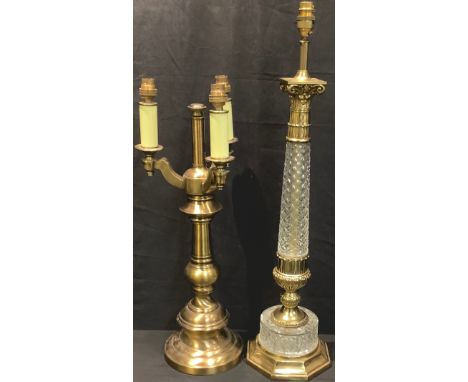 A large brass and glass Corinthian column table lamp, 72cm high; another, three branch brass table lamp, 59cm high (2) 