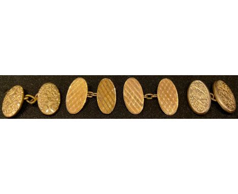 A pair of 9ct rose gold engine turned oval cuff links, 4.6g; a near pair of gold plated cuff links 