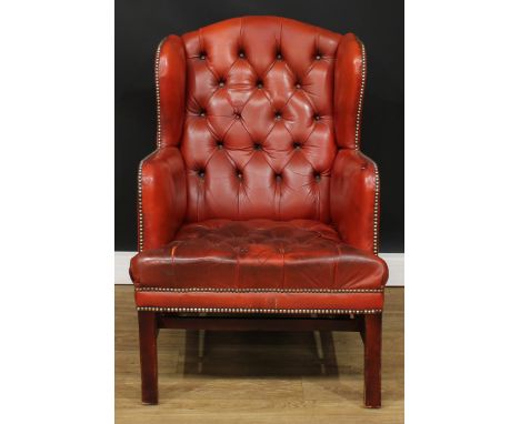 An office reception Chesterfield wingback armchair, deep-button back and seat, 98cm high, 70cm wide, the seat 47cm wide and 5