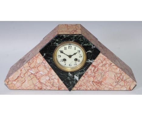 An Art Deco marble mantel clock, 9cm circular dial inscribed with Roman numerals, 22cm high, 47cm wide 