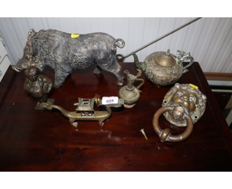 A brass door knocker in the form of a lion, a cigar cutter, brass teapot, ornament in the form of a ball etc.