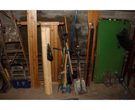 A collection of garden tools including shovels; an axe; garden hoe etc