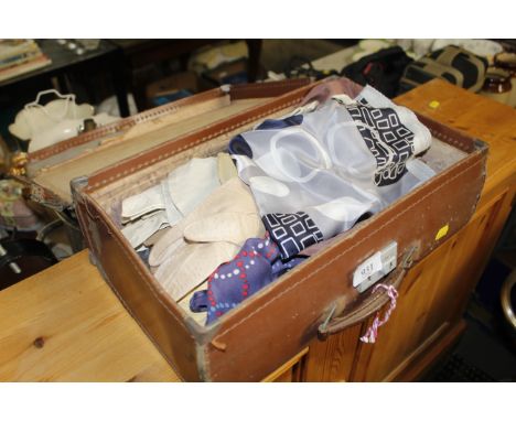 A vintage small suitcase and contents of lady's scarves and gloves