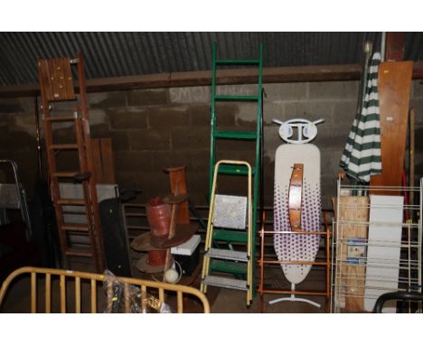 Two metal step ladders; edging sheers and a rake 