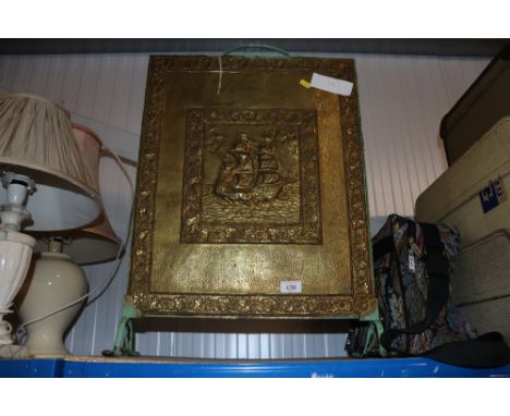 A brass firescreen
