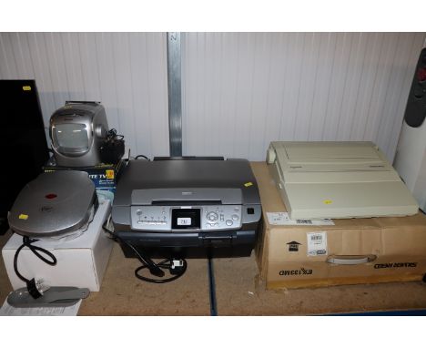 An Epson printer/scanner, a Silver Reed typewriter, a portable black and white TV and a Cotton Traders sandwich machine