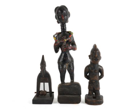 THREE AFRICAN TRIBAL FIGURES (3)Including a Senufo heddle pulley, modelled as a bird, the tallest, 43cm high