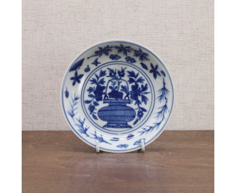 A Chinese blue and white saucer, Wanli (1573-1620), the rounded sides rising from a circular foot, the centre painted with an