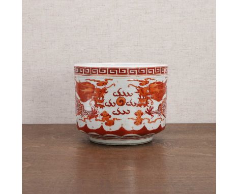 A Chinese iron-red glazed incense burner, early 20th century, the cylindrical body rising from a circular foot, painted with 