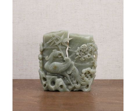 A Chinese jade carving, 20th century, of a phoenix standing in front of bamboo, surrounded by rocks and lingzhi, 13.8cm highC