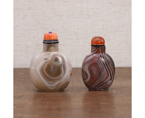 Two Chinese agate snuff bottles, Qing dynasty (1644-1911), the larger one carved with lingzhi, the stopper with a coral caboc