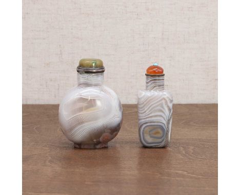 Two Chinese agate snuff bottles, Qing dynasty (1644-1911), comprising: one of agate and jasper, rounded, the stopper with a j