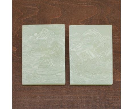 A pair of Chinese jade plaques, 20th century, of rectangular form, each carved with a landscape to one side and an inscriptio