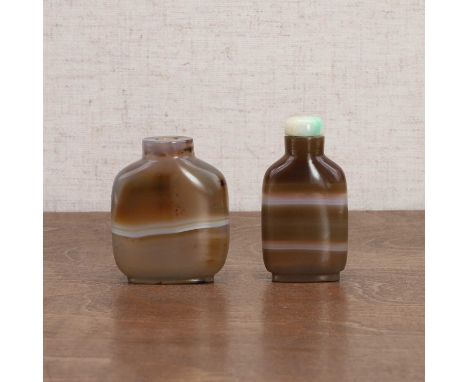 Two Chinese agate snuff bottles, Qing dynasty (1644-1911), plain, the stone well hollowed with horizontal bands, one stopper 