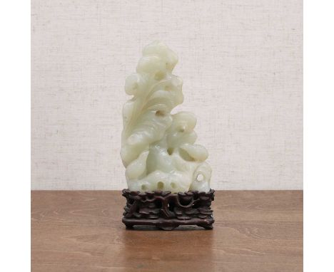 A Chinese jade carving, 20th century, pierced and carved with two quail amidst stalks of millet by a rock,11.5cm high, wood s