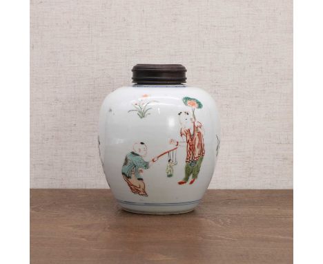 A Chinese wucai jar, Kangxi (1662-1722), of tapering form, painted with boys at play, surrounded by butterflies and sprigs of
