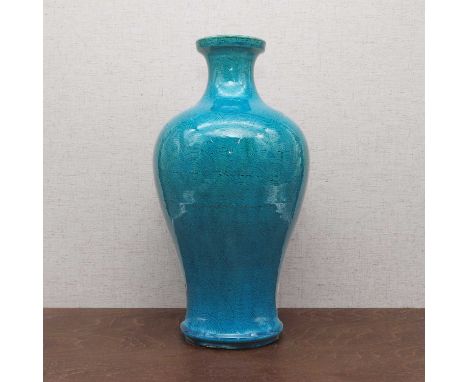 A Chinese turquoise-glazed vase, Qing dynasty (1644-1911), of baluster form, painted with a dragon chasing a flaming pearl am