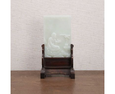 A Chinese jade table screen, 20th century, of rectangular form, carved with a luohan seated in front of an incense burner by 