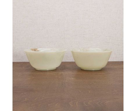 A pair of Chinese jade bowls, 20th century, each with rounded sides with a flared rim, supported by a circular foot, plain,16