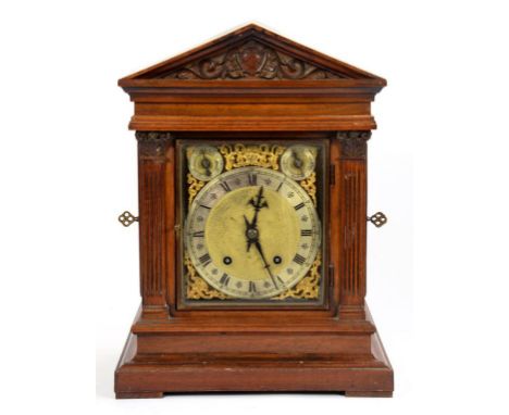 A GERMAN ARCHITECTURAL CARVED WALNUT BRACKET CLOCK WITH TRIANGULAR PEDIMENT AND BRASS DIAL, THE SUBSIDIARY STRIKE/SILENT AND 