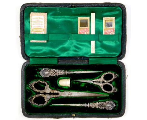 NEEDLEWORK TOOLS.  A VICTORIAN SILVER FIVE PIECE SEWING SET, INCLUDING A THIMBLE, BIRMINGHAM 1898, WORN LEATHER CASE