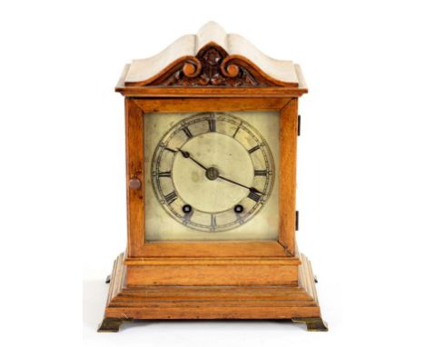 A GERMAN MAHOGANY MANTLE CLOCK WITH CARVED PEDIMENT, THE SILVERED SQUARE DIAL WITH BLUE STEEL HANDS, WINTERHALDER & HOFMEIER 