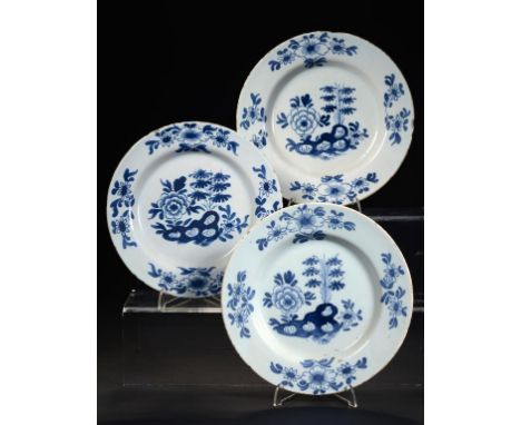 THREE ENGLISH DELFTWARE PLATES,  PROBABLY BRISTOL, C1760 painted in cobalt with a Peony and Rock pattern, 22.5-24cm diam ++Tw